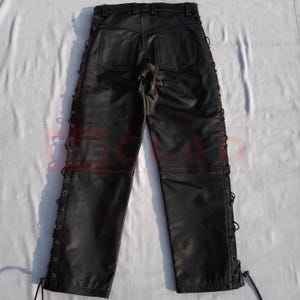May include: Black leather pants with lace-up detailing on the sides. The pants have a classic five-pocket design and a straight leg.