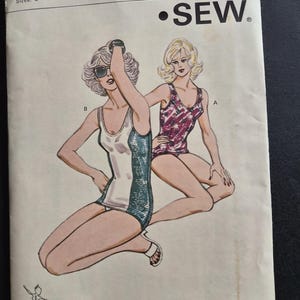 May include: A Kwik Sew pattern envelope 1012 for sizes 8-14 featuring illustrations of two swimsuits. One is a white and teal one-piece, and the other is a purple and white patterned one-piece. The envelope includes the brand name and address.