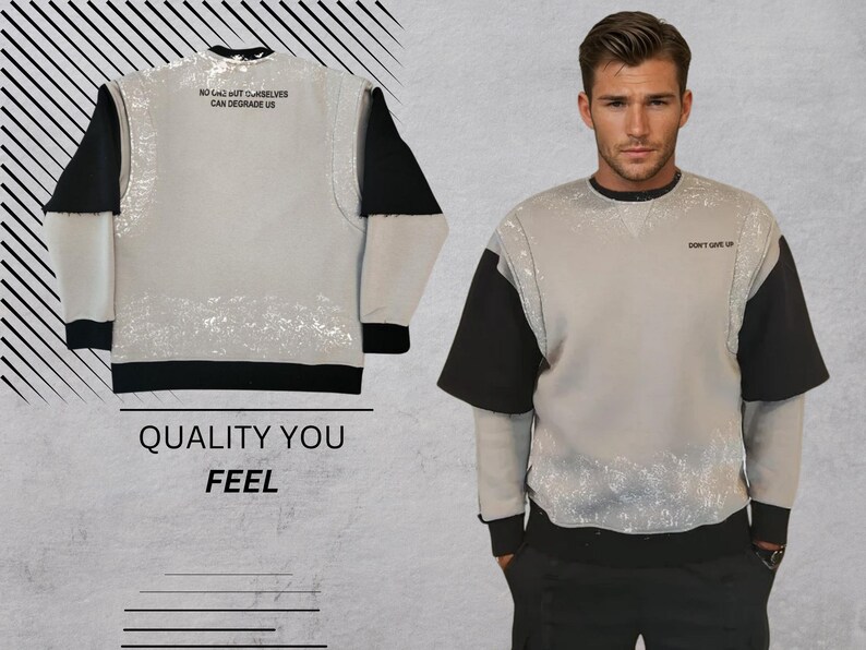 May include: A gray sweatshirt with black sleeves and a white splatter pattern. The front of the sweatshirt has the text "NO LIMIT BUT OURSELVES CAN DEGRADE US" printed on the top and "DON'T GIVE UP" printed on the bottom.
