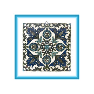May include: A square ceramic tile featuring a symmetrical floral pattern in shades of deep blue, turquoise, and dark green on a white background, framed by a bright blue border with a soft white gradient effect around the inner edge.