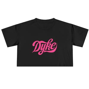 May include: Black cropped t-shirt with a pink "Dyke" graphic in a retro font.