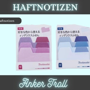 Könnte beinhalten: Zwei Packungen Haftnotiz-Lesezeichen. Eine Packung zeigt rosa und lila Farbtöne, die andere blau. Jede Packung enthält 60 Blatt und hat japanischen Text. Das Wort "Bookmarks" ist unten aufgedruckt.