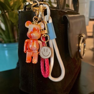 Bag charms, Bag jewelry, Bag charms, with orange teddy bear and cords, bag accessories and key ring