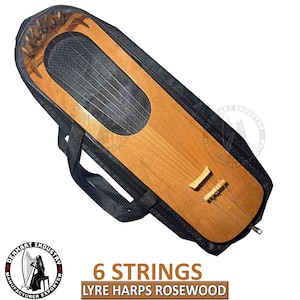 May include: A rosewood lyre harp with six strings, in a black case. The instrument has a light brown wooden body and a dark interior. The text "6 Strings Lyre Harps Rosewood" is at the bottom of the image.