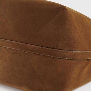 premium suede texture ideal for autumn and winter outfits
High quality large suede leather tote for women featuring soft brown suede material strong stitching and a comfortable shoulder strap
Stylish and practical brown suede tote purse for women with a roomy design adjustable strap and durable leather construction for everyday wear
Minimalist brown suede leather tote bag with spacious interior perfect for work meetings shopping trips and casual weekend outings
Handmade suede leather handbag in