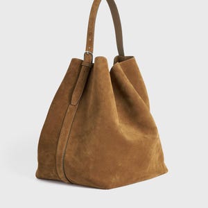 Elegant large suede leather tote in rich brown color for women featuring genuine cowhide leather construction and spacious functional interior
Handcrafted brown suede leather tote bag with adjustable shoulder strap perfect as an everyday handbag for work shopping or travel
Oversized brown suede tote purse for women made from 100 percent genuine cowhide leather designed for durability and timeless style
Brown suede leather carryall tote with adjustable handle spacious compartment and premium