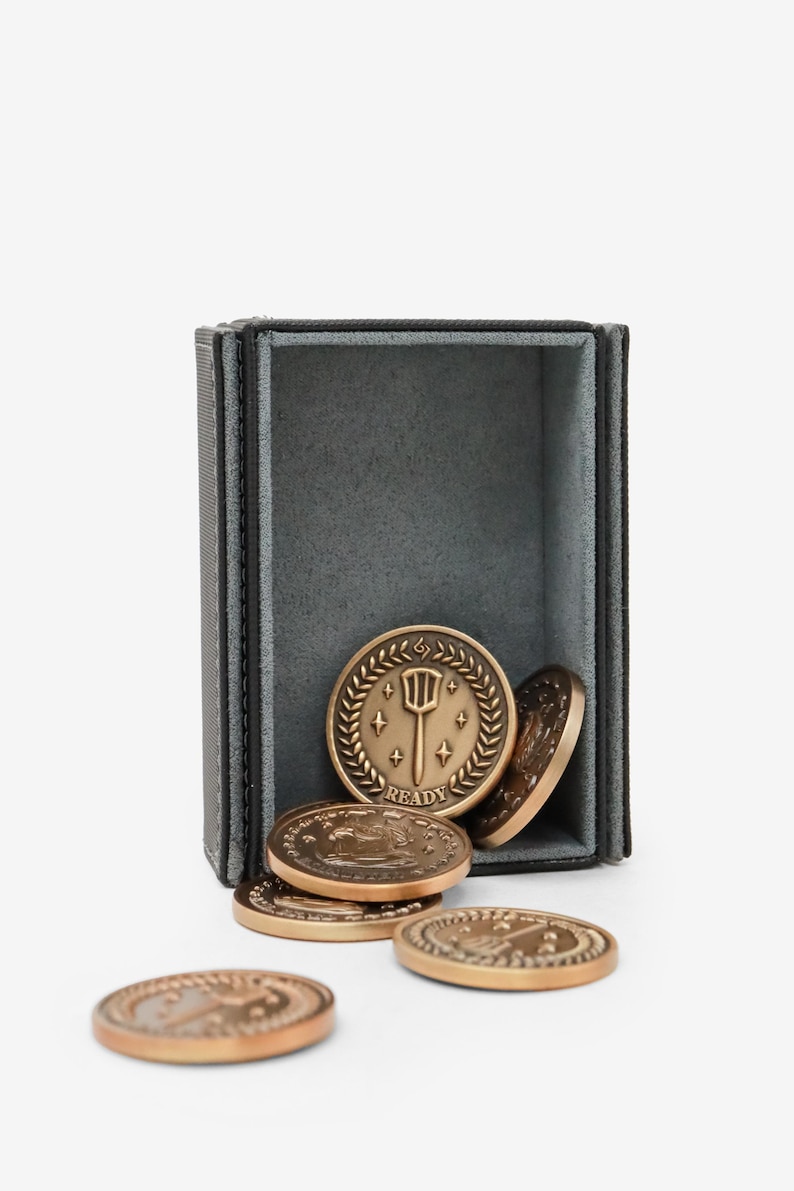 Riftbound gold coin tokens spilling from a deck box — antique gold zinc alloy, Ready and Exhausted faces