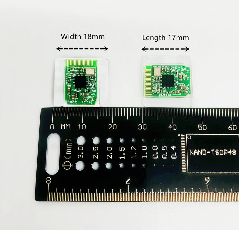May include: Two small green circuit boards, one 18mm wide and the other 17mm long, are displayed on a white surface. A black ruler with millimeter markings and the text "NAND-TSOP48" is in the foreground.