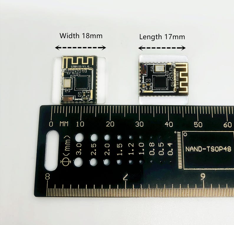 May include: Two small black and gold electronic components, each mounted on a clear plastic base, are displayed next to a ruler. The components measure 18mm wide and 17mm long. The ruler is marked in millimeters.