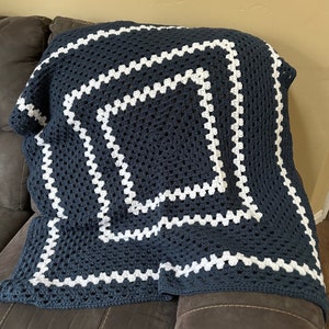 Soft handmade crochet baby blanket afghan. Navy blue and white.