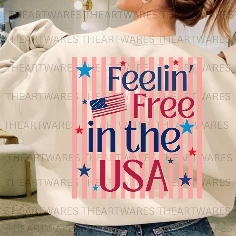 May include: Cream-colored sweatshirt with the text "Feelin' Free in the USA" in red and blue, along with an American flag graphic. The design includes pink vertical stripes and star accents.
