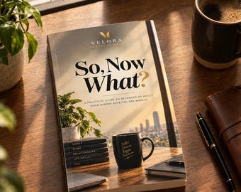 May include: A softcover book titled So, Now What? A Practical Guide to Becoming an Adult When Nobody Gave You the Manual by Velora Publishing. The cover features a desk scene with a plant, a black mug, and a stack of books labelled Money, Work, Relationships, Life Skills, and You.