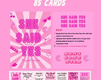 May include: Pink and white printable game cards with the title "She Said Yes" and the text "The girliest card game". The cards feature different game options like "Bride Trivia", "Must Do", "Never Have I Ever", "Two Truths and a Lie", "Drink or Dare", and "She Said Yes".