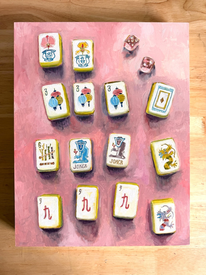 May include: A painting of Mahjong tiles and dice on a pink background. The tiles feature various symbols, numbers, and the word "Joker." The dice are translucent with visible dots. The artwork is a close-up view of the game pieces.
