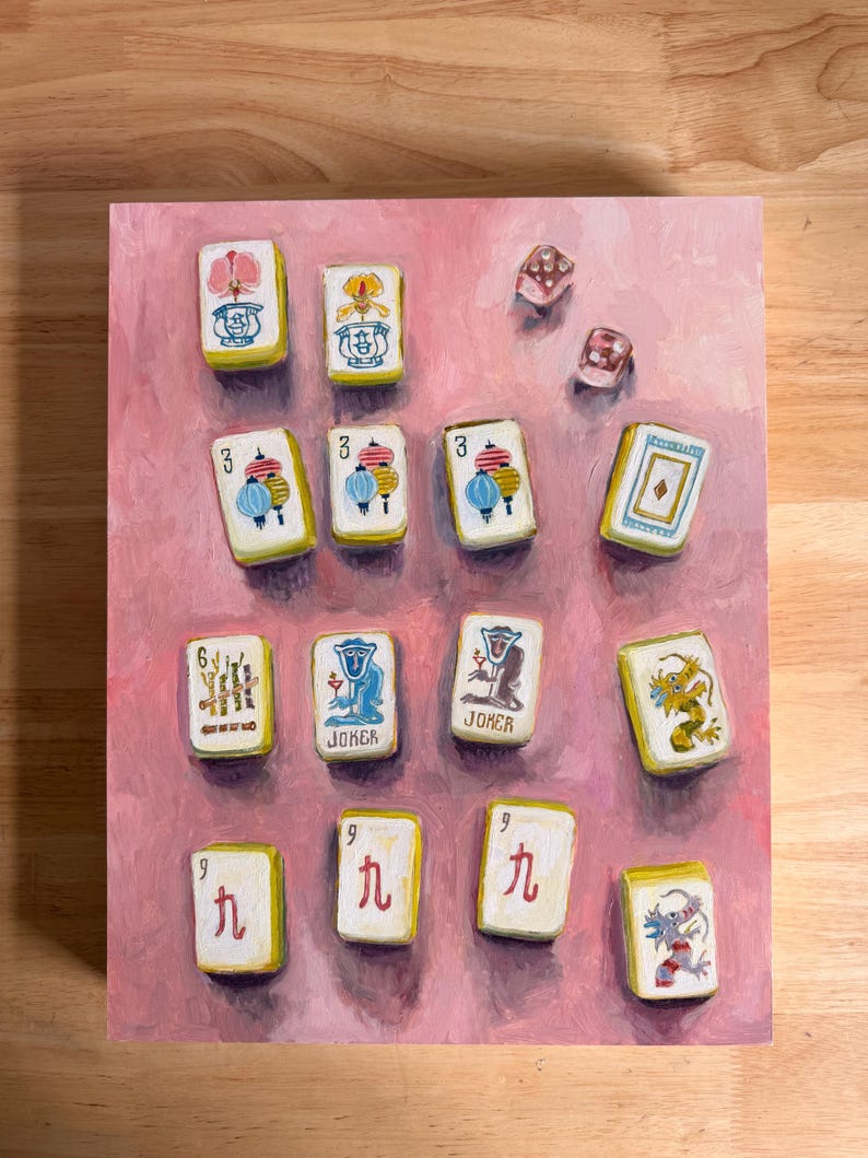 May include: A painting of Mahjong tiles and dice on a pink background. The tiles are white with colorful illustrations and Chinese characters. The dice are translucent with red dots. The artwork is a still life.
