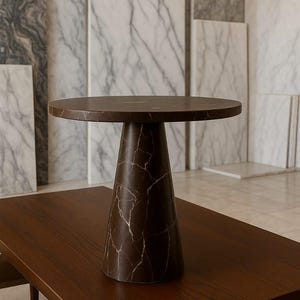 May include: A brown marble-topped side table with a conical base, set on a dark wood table. The marble has a distinctive veined pattern. The table is approximately 24 inches in height and 20 inches in diameter.
