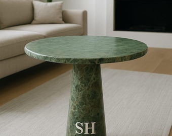 May include: A green marble side table with a round top and a conical base. The table has a polished finish and features the text "SH MARBLE HANDIGRAFTS" in white. The table is approximately 24 inches in height.