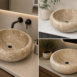 May include: A round vessel sink crafted from beige natural stone with a textured, mottled surface. The basin features a smooth, polished interior bowl and a central drain hole, showcasing the organic veining and earthy color variations of the stone.