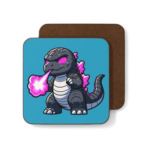 May include: A blue coaster featuring a cartoon image of a black and pink Godzilla-like monster breathing fire. The monster has glowing red eyes and a pink tongue.