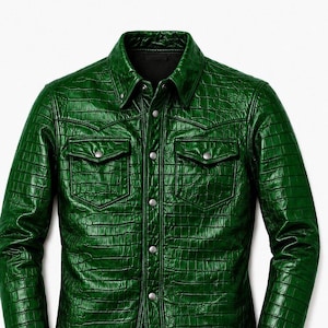 May include: A long-sleeved button-down shirt in a vibrant emerald green color with a glossy, embossed crocodile skin texture. The shirt features a classic collar, two chest pockets with buttoned flaps, and silver-toned metal snap buttons.