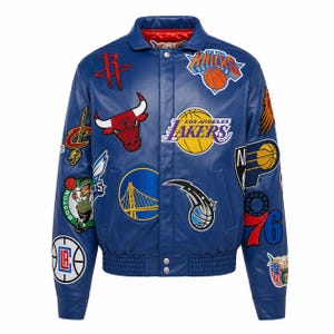 Puede incluir: Una chaqueta universitaria de cuero azul con varios logotipos bordados de equipos de la NBA, incluidos los Chicago Bulls, Los Angeles Lakers, Golden State Warriors y New York Knicks. La chaqueta tiene cuello, cierres de botones a presión y puños acanalados.