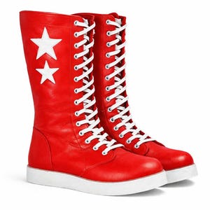 May include: A pair of red, lace-up boots with white soles. Two white stars are on the side of the left boot. The boots have white laces and a high-top design, suitable for various outfits.