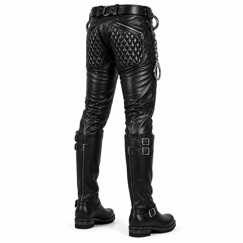 May include: Black pants featuring quilted panels on the back and sides, a belt with metal hardware, and a silver-toned chain accessory. The pants are paired with black knee-high boots that have vertical zippers, double buckle straps, and block heels.