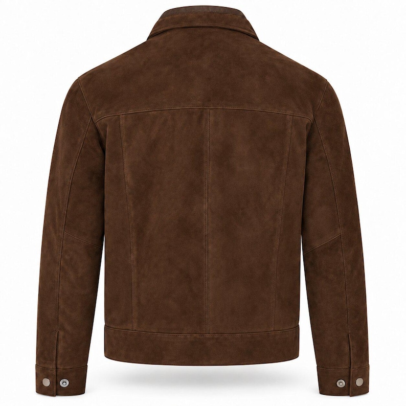Peut inclure: Une veste en daim marron fonc&eacute; vue de dos, dot&eacute;e d'un col classique, d'un empi&egrave;cement horizontal dans le dos, de coutures verticales et de manches longues avec poignets boutonn&eacute;s. La veste pr&eacute;sente une coupe structur&eacute;e avec un ourlet droit.