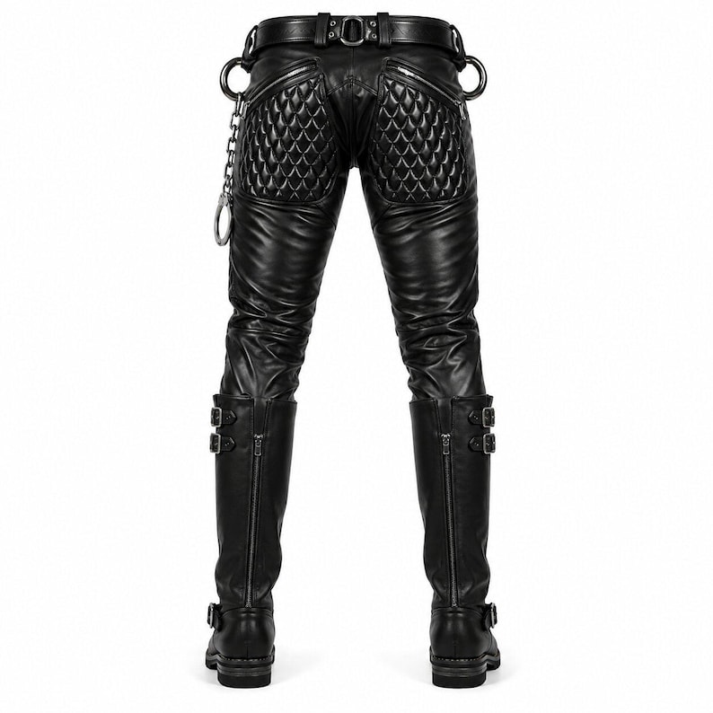May include: Black leather pants featuring quilted panels on the back, a belt with metal loops, and a silver chain attachment. The pants are paired with tall black leather boots that have double buckle straps and vertical zippers on the back.