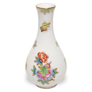 May include: A white porcelain vase with a gold rim and floral and butterfly designs. The vase features a large peony with orange, pink, and blue petals, and a yellow butterfly. The vase is approximately 8 inches tall.