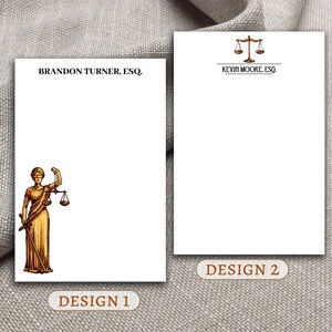 May include: Two designs for legal stationery. The first design features a drawing of the figure of justice holding a sword and scales. The second design features a simple drawing of scales of justice. Both designs include the text "ESQ" and a name.
