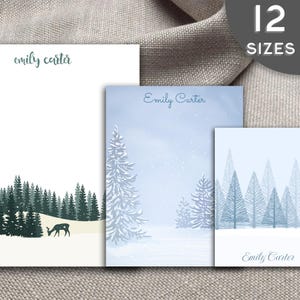 May include: Three different designs of personalized stationery featuring a winter forest scene with trees and a deer. The stationery is white with blue and green accents. The name "Emily Carter" is printed on each design.