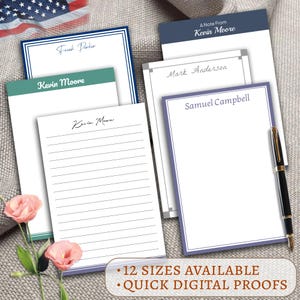 May include: A collection of personalized notepads with various border colors, including blue, green, and purple. Each notepad features a name at the top, with some lined and others blank. A pen rests on the side. Text reads: "12 Sizes Available" and "Quick Digital Proofs."
