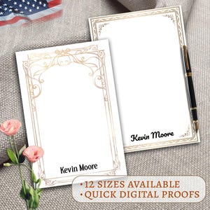 May include: Two white stationery note cards with a gold decorative border. The text "Kevin Moore" is printed at the bottom of each card. The text "12 SIZES AVAILABLE" and "QUICK DIGITAL PROOFS" is printed below the cards.