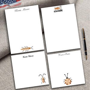 May include: Set of four white notepads with a bug design and the name "Kevin Moore" printed on each. The bugs are brown and orange with black eyes.