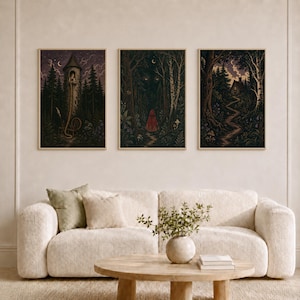 May include: Three framed vertical wall art prints featuring dark, atmospheric forest scenes. The left print shows a tower with a figure, the center depicts a figure in a red cloak in a dark forest, and the right shows a path leading to a cottage.