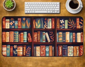 May include: A rectangular desk mat featuring a detailed illustration of a wooden bookshelf filled with numerous books. The book spines display a variety of colours including blue, orange, red, and cream, decorated with intricate floral and leaf patterns.