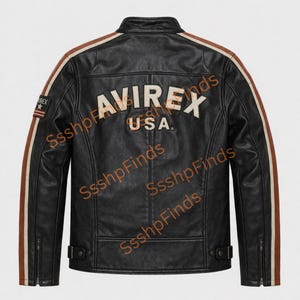 May include: Black leather jacket with brown and cream stripes on the sleeves and shoulders. The back of the jacket features the word "AVIREX" above "USA" in cream-colored lettering. A small patch with text is on the left sleeve.