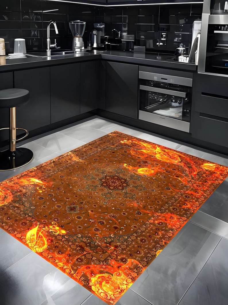 May include: A large, intricately patterned rug with a fiery orange and yellow design. The rug has a traditional Persian style with a central medallion and floral motifs. The rug is laid out on a gray tiled floor in a modern kitchen.