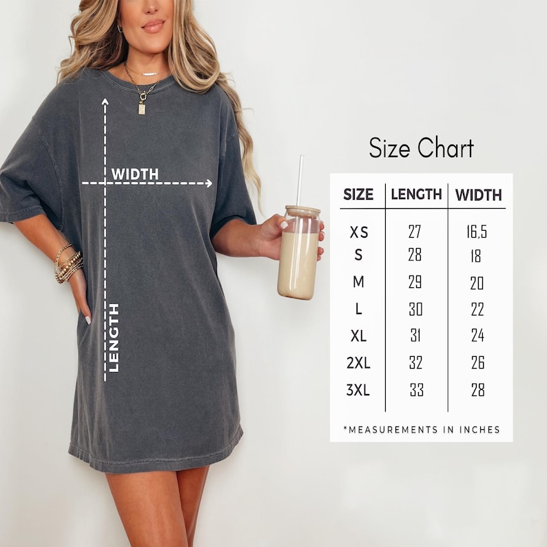 May include: A charcoal grey short-sleeve t-shirt with a size chart displaying length and width measurements in inches. The chart lists sizes from XS to 3XL with corresponding dimensions, and dashed lines on the shirt indicate how to measure.