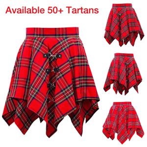 May include: Red tartan skirt with an asymmetrical hem. The skirt has black leather straps with silver buckles and a high waist. The image includes the text "Available 50+ Tartans".