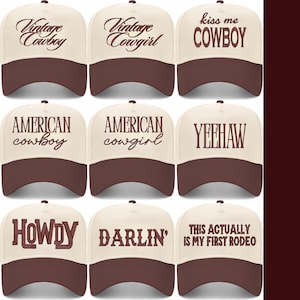 May include: Nine baseball caps with a cream-coloured crown and a brown peak. Each cap features a different text design, including "Vintage Cowboy", "Vintage Cowgirl", "Kiss Me Cowboy", "American Cowboy", and "Yeehaw".