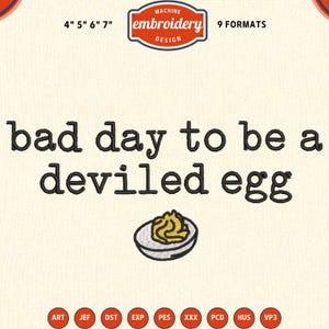 May include: A machine embroidery design featuring the black text 'bad day to be a deviled egg' above a small, embroidered illustration of a halved deviled egg with a yellow yolk and white egg white, including size labels 4" 5" 6" 7".