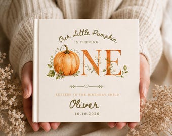 May include: A square hardcover book with a cream-colored cover featuring a watercolor pumpkin illustration. The text reads Our Little Pumpkin IS TURNING ONE, LETTERS TO THE BIRTHDAY CHILD, the name Oliver, and the date 10.10.2026 in brown and orange.