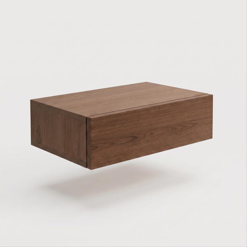 May include: A rectangular floating wall shelf constructed from dark brown wood with a visible natural grain pattern. The shelf features a clean, box-like design with a solid front panel and side edges, presenting a smooth, flat top surface.