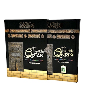 May include: Two black hardback books with gold accents and the words "The Holy Quran" on the front. The books are titled "Colour Coded Tajweed Rules" and feature a picture of the Kaaba.