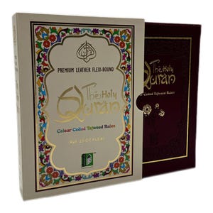 May include: A white box with gold lettering and colourful accents. The box contains a copy of The Holy Quran with colour-coded Tajweed rules. The box is labelled "Premium Leather Flexi-Bound" and "Ref. 23-CC FLEXI".