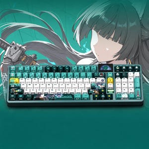 May include: A mechanical keyboard featuring a teal and white color scheme with custom keycaps decorated with anime-style character illustrations and symbols. The keyboard includes a small circular display screen in the upper right corner.