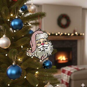May include: A Christmas tree decorated with blue and silver ornaments. A Santa Claus ornament with a red and white hat and a dotted design hangs from the tree. The ornament has a red string for hanging.