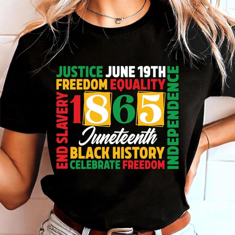 May include: Black t-shirt with a colorful graphic design. The design includes the words "JUSTICE JUNE 19TH FREEDOM EQUALITY" and "1865 Juneteenth BLACK HISTORY CELEBRATE FREEDOM". The words "END SLAVERY" and "INDEPENDENCE" are also included.